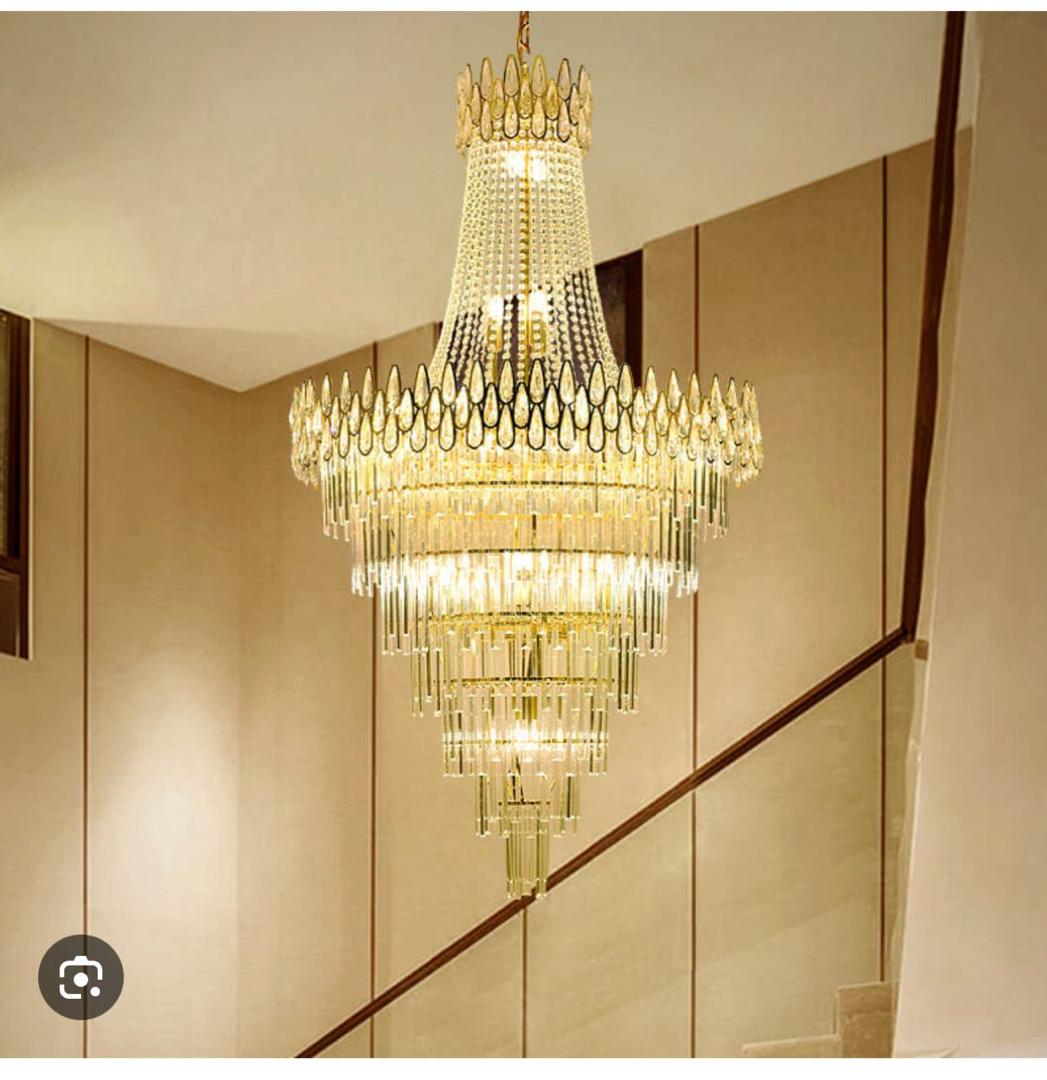 Gold crystal chandelier hanging over a staircase